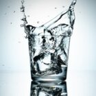 a glass filled with water on top of a table