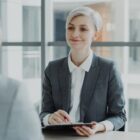 Confident woman interviewing candidate in a modern office. Ideal for business and HR visuals.
