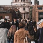 A stunning view of St. Paul's Cathedral captured from Millennium Bridge in London, with people in the foreground.