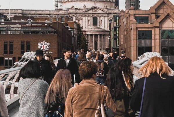 A stunning view of St. Paul's Cathedral captured from Millennium Bridge in London, with people in the foreground.